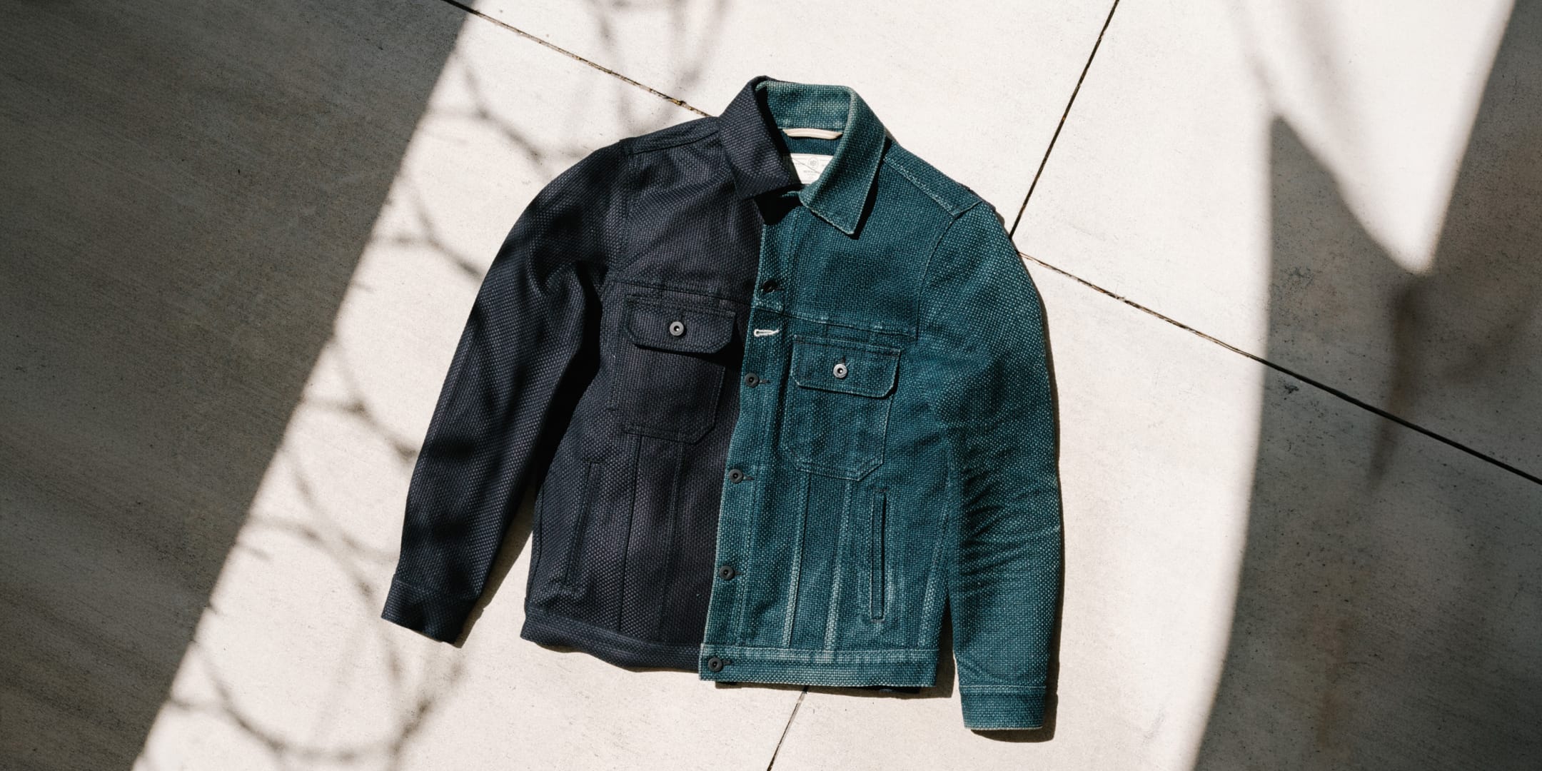 Blue denim jacket on a white marble surface