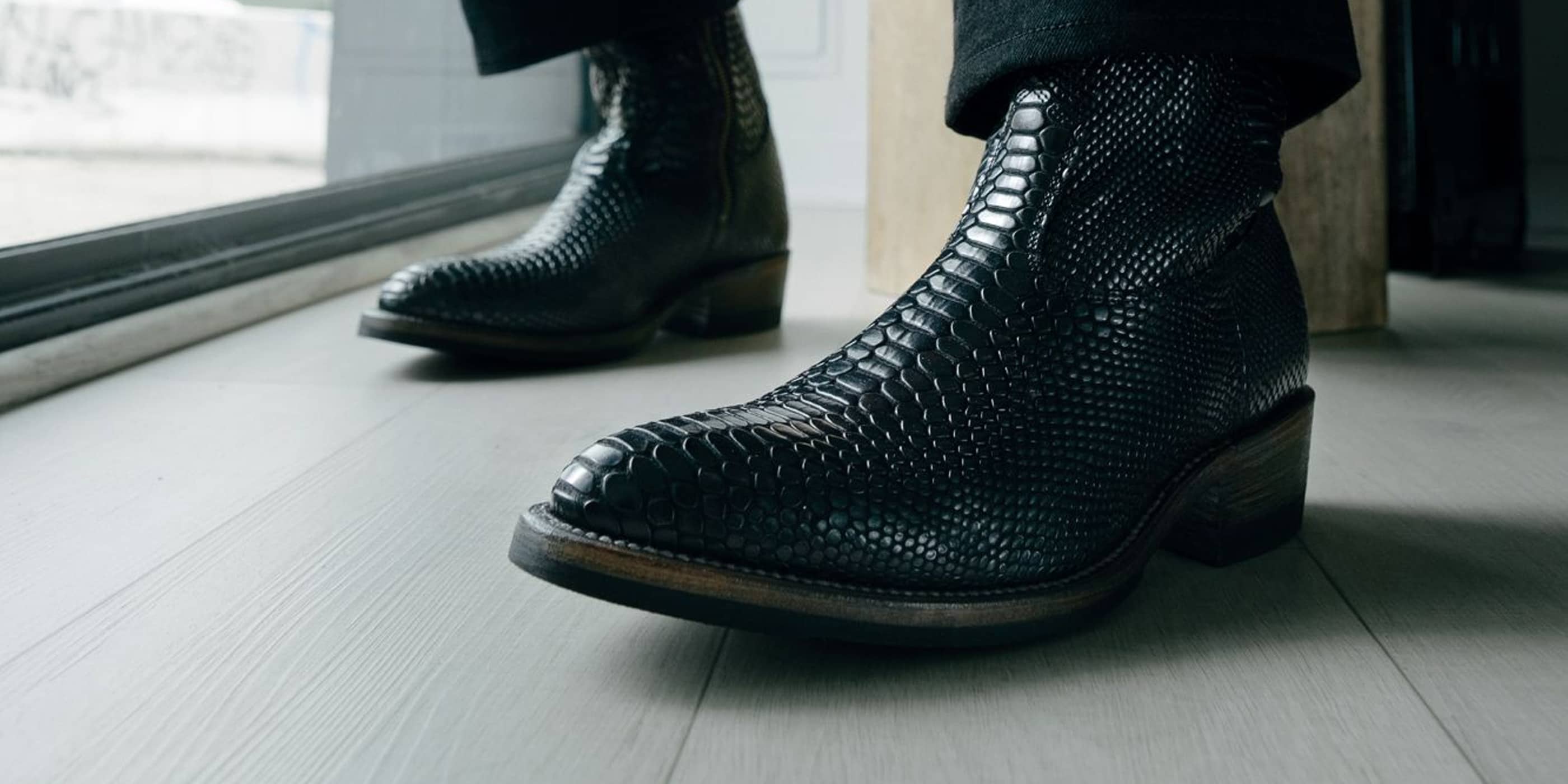 Man wearing Alden x SOP Wick boots in black snake