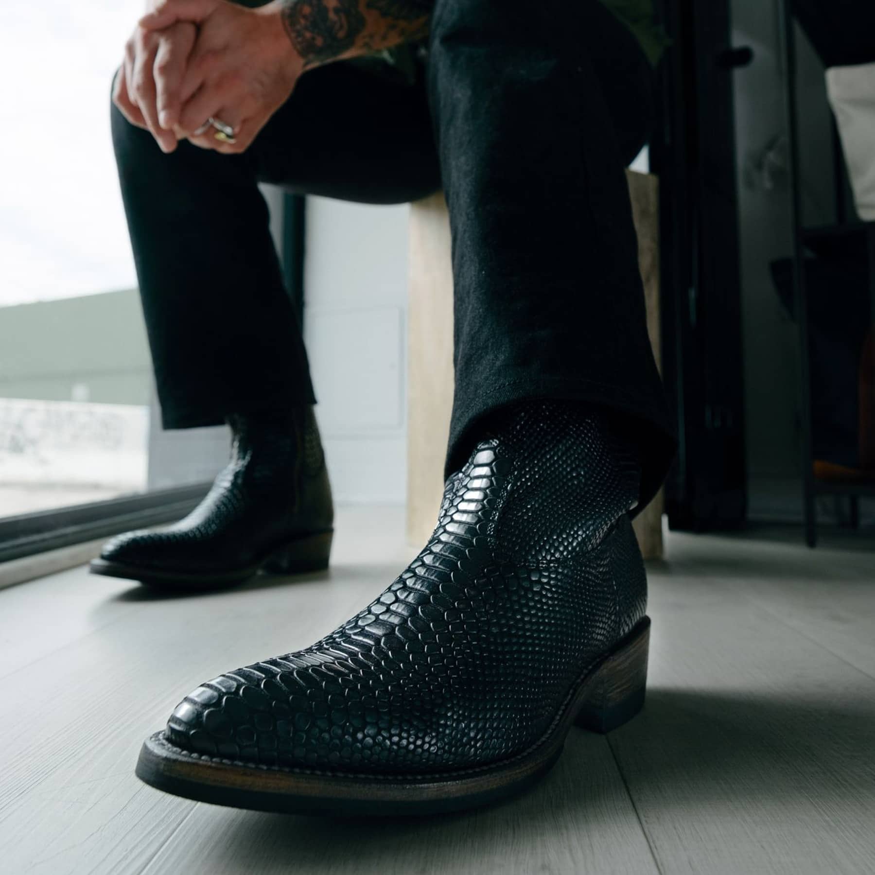 Man wearing Alden x SOP Wick boots in black snake
