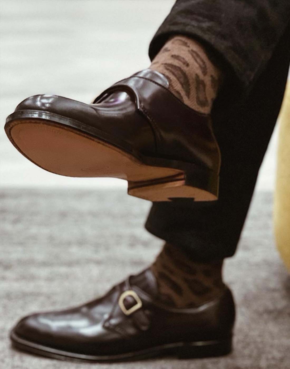 Man wearing leopard print socks and Alden single-strap monk shoes in brown