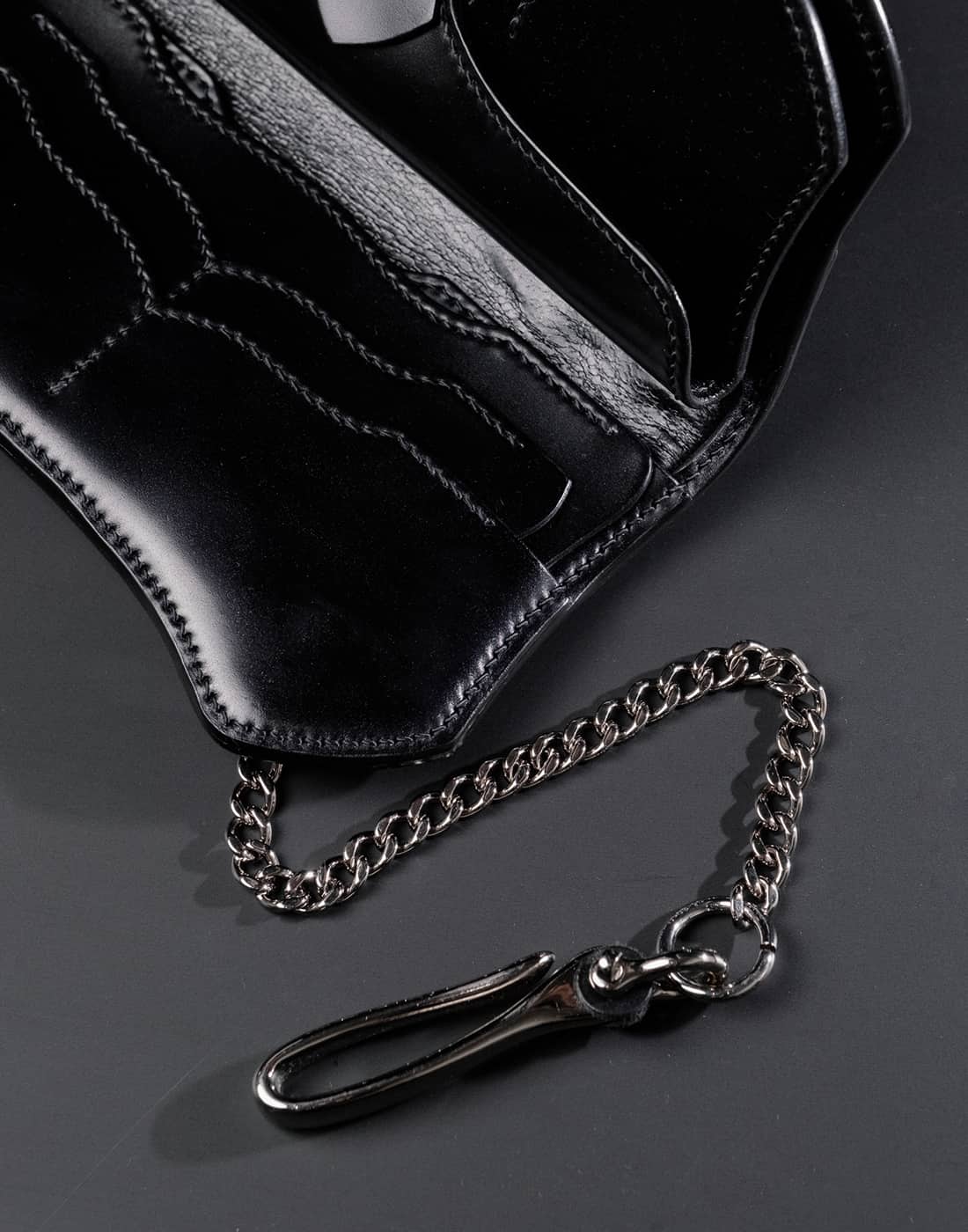 Closeup of black leather wallet and silver chain