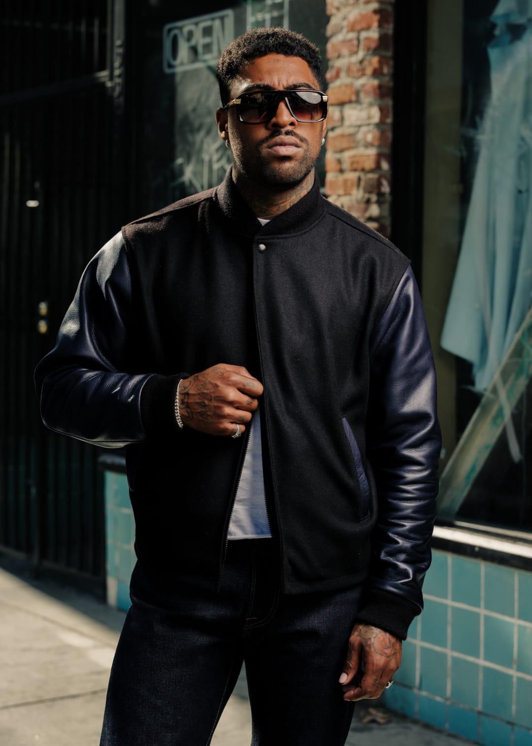 man wearing varsity jacket