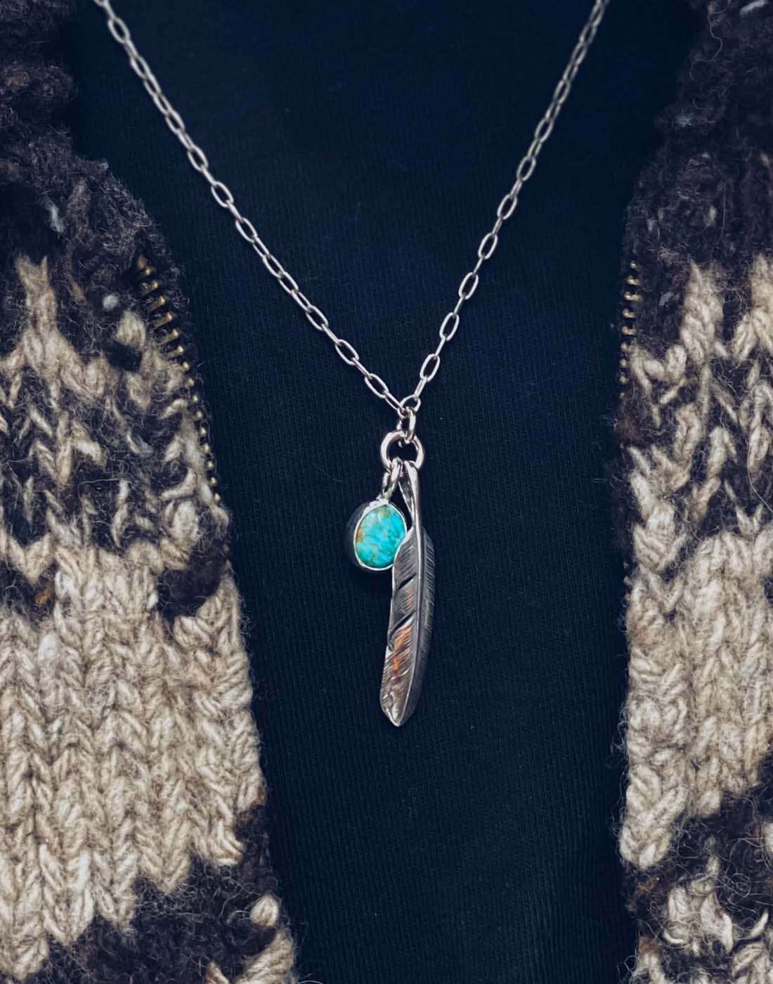 Close-up of man wearing Mt. Hill Sterling Silver Feather Chain Necklace with Turquoise