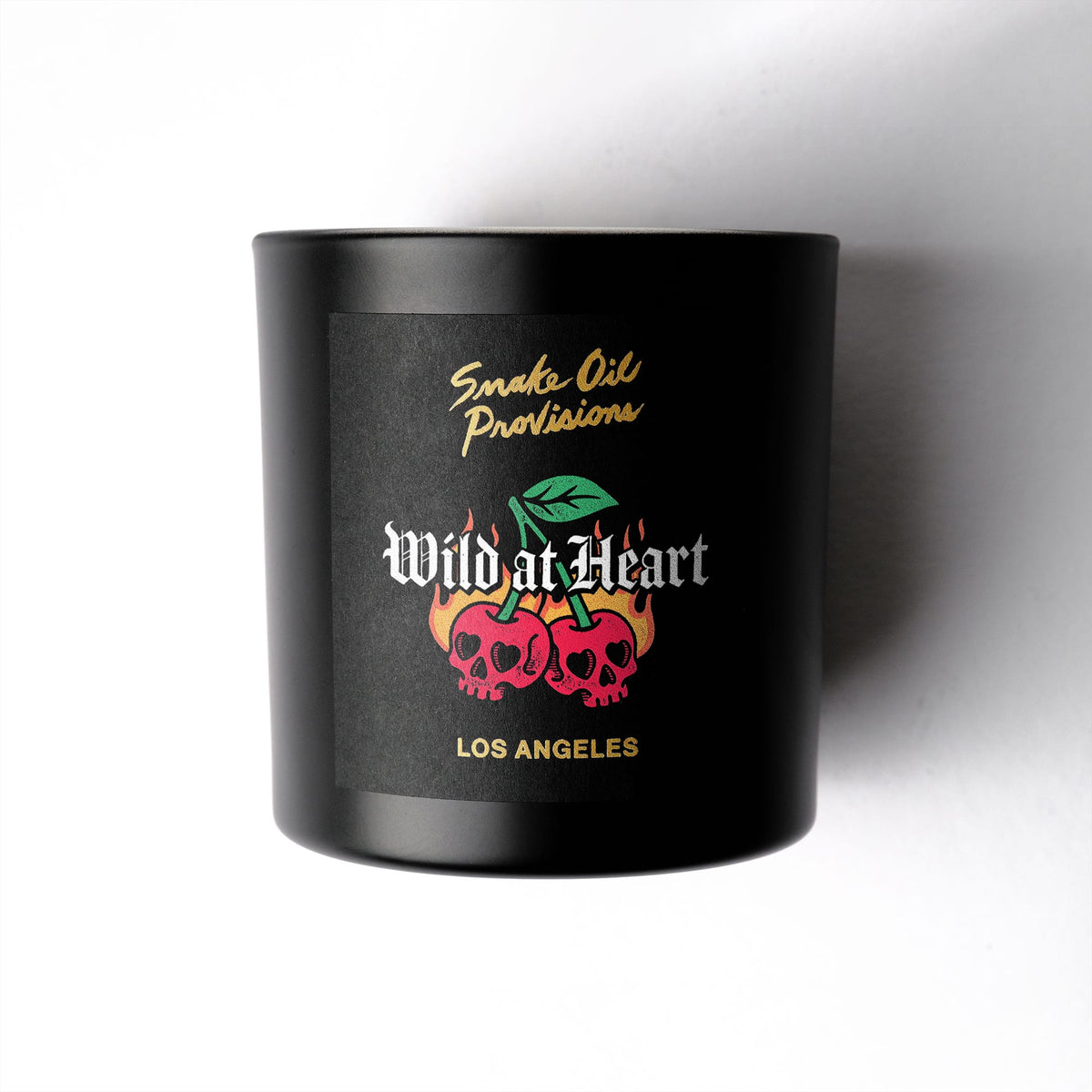 Black candle with 'Wild at Heart' branding on a white background