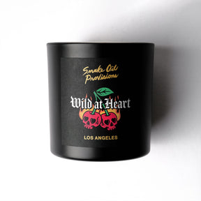 Black candle with 'Wild at Heart' branding on a white background